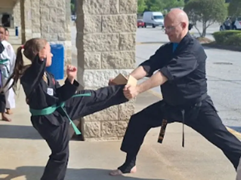 Happy kids in Snellville learning martial arts, improving balance, coordination, and having fun while building life skills.