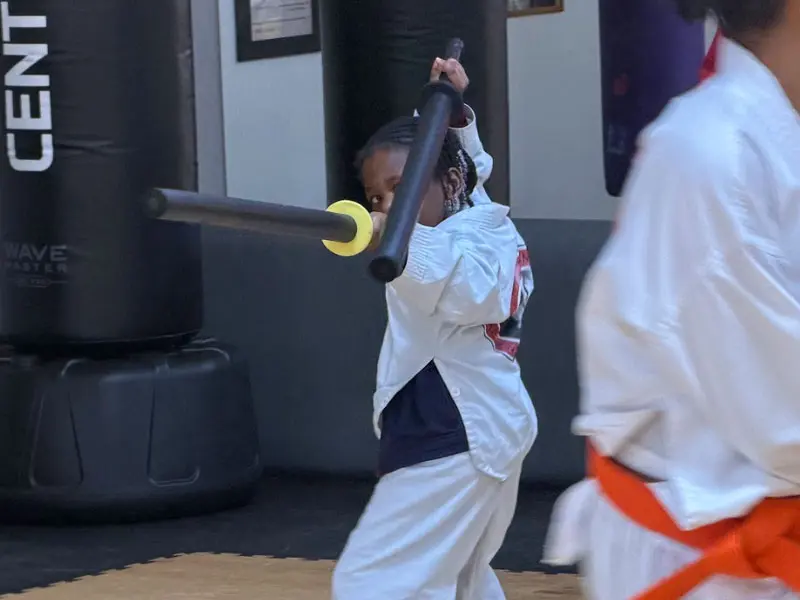 kids in Snellville martial arts class improving focus, discipline, and listening skills through martial arts training